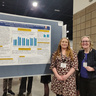 Simone Schnall and Emily McKendrick standing in front of poster at SPSP conference